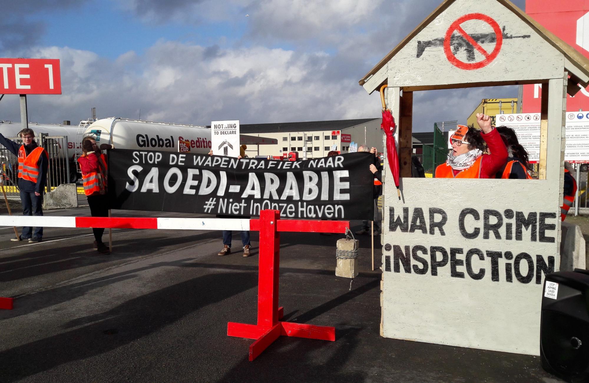 Action at the port of Antwerp - banner says stop arming saudi in Dutch